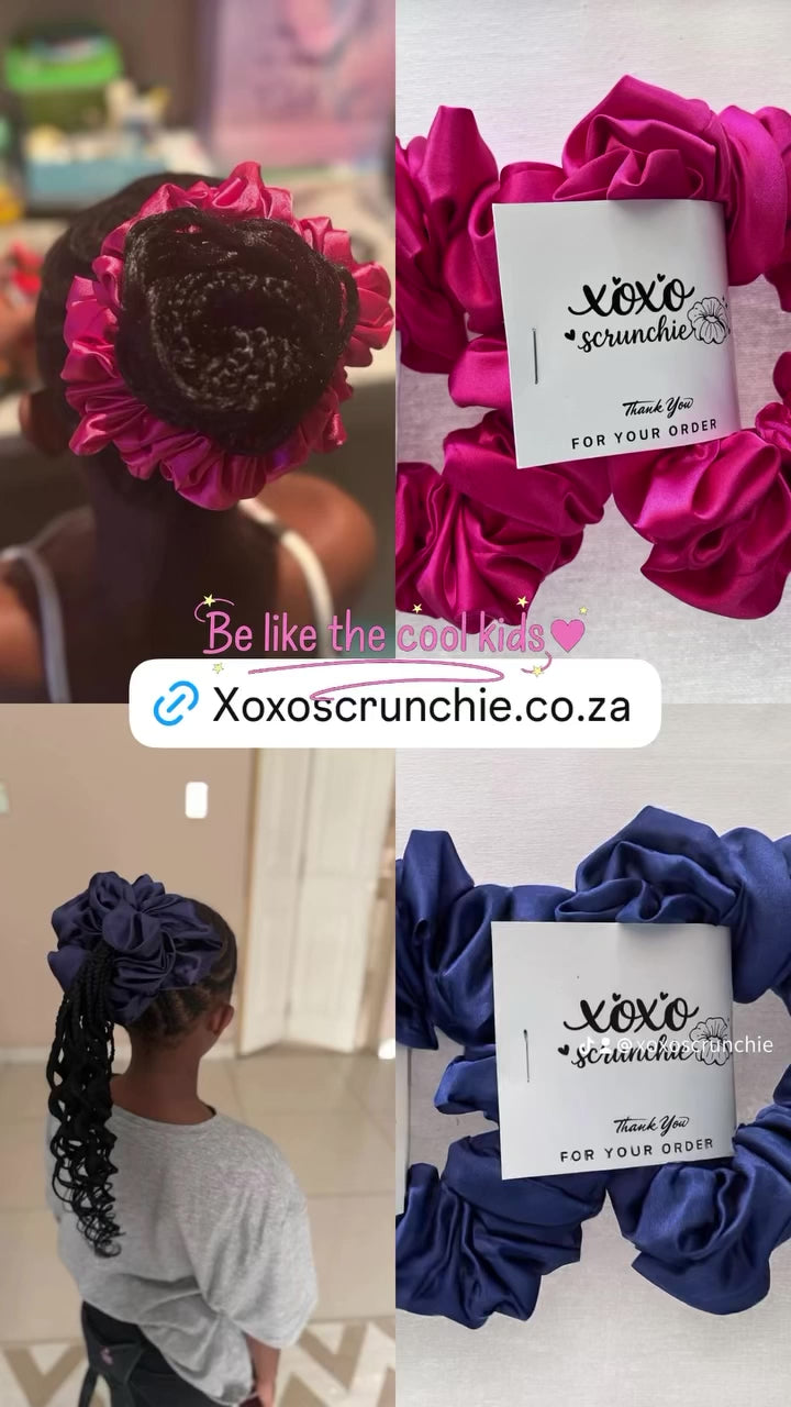 Child wearing pink satin hair scrunchie in ponytail